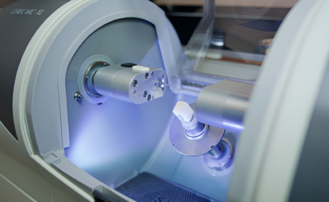 Dental sterilization equipment with blue UV light illuminating internal chamber and instruments.